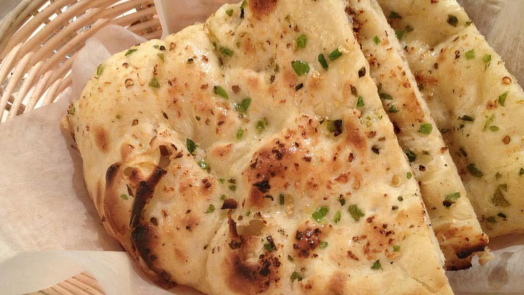 Garlic & Chilli Naan · Hamemade naan topped with green chilli and baked on indian clay oven.