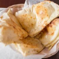 Traditional Plain Naan · Hand stretched naan baked in tandoor oven.