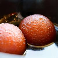 Gulab Jamun-2pcs · Golden fried balls made from powdered milk, soaked in a sweet saffron syrup. Served warm.