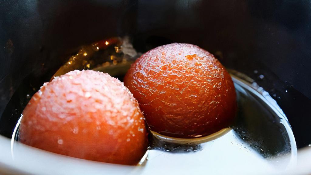 Gulab Jamun-2pcs · Golden fried balls made from powdered milk, soaked in a sweet saffron syrup. Served warm.