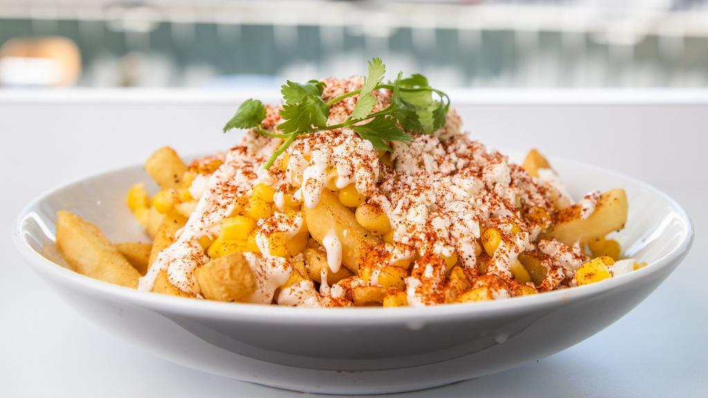 Elote Fries · French Fries topped with cotija cheese, mayo, sour cream, corn, chili pepper and cilantro.