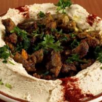 Hummus with Shawarma · Hummus dip topped with seasoned coarse shawarma, mixed with olive oil and spices.