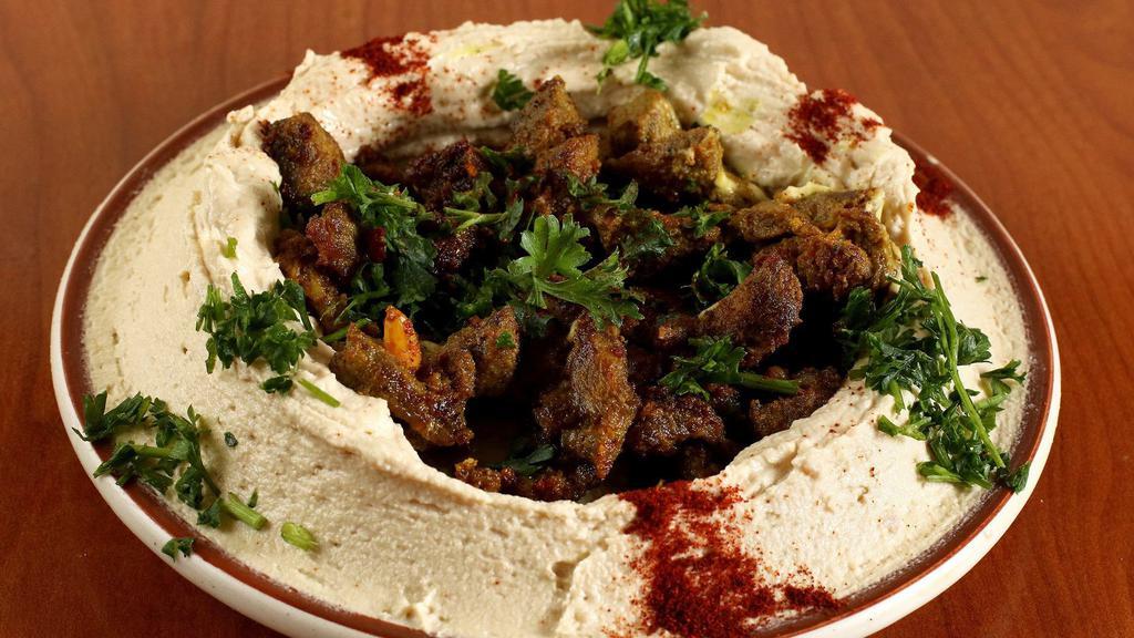 Hummus with Shawarma · Hummus dip topped with seasoned coarse shawarma, mixed with olive oil and spices.