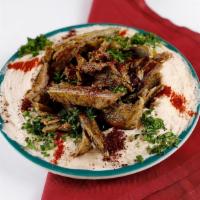 Hummus with Meat · Hummus dip topped with seasoned coarse lamb mixed with olive oil and spices.