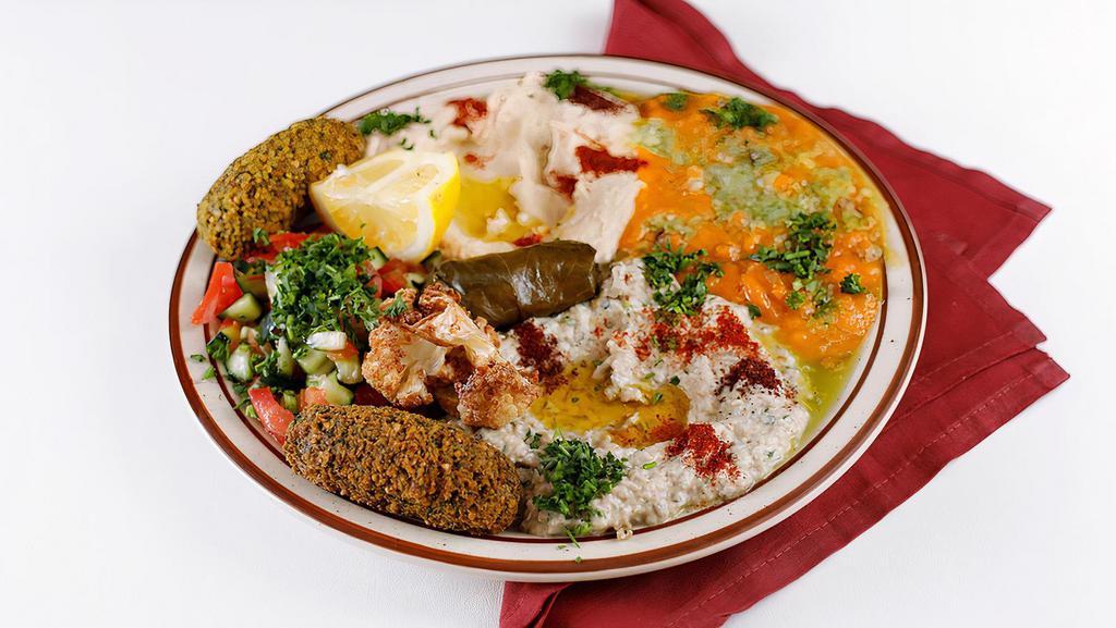 Vegeterian Combo · Combination of falafel, hummus, ful, dolma, baba ghanoush, Arabic salad, eggplant and cauliflower.
