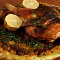 Mousakhan · Savory Palestinian dish of oven-roasted half chicken atop freshly baked Arab flatbread with ...