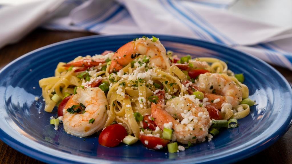 Athenian Prawns · Sautéed jumbo prawns, extra virgin olive oil, fresh garlic, tomatoes, sweet basil, tossed in linguine, with crumbled feta and Greek seasonings.