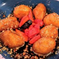 Loukoumades · Rounds of crisp, fried dough tossed in cinnamon & powdered sugar, drizzled with thyme-honey ...