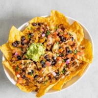Mas Nachos · Crispy tortilla chips topped with Impossible ™ savory tex-mex style taco meat, queso sauce, ...