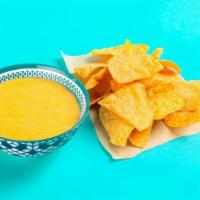 Chips + Queso · Crispy tortilla chips served with warm house-made queso sauce. Gluten-friendly. .