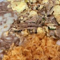 Huevos Machaca · Scrambled eggs with shredded beef and bell peppers. Served with rice and beans . Your choice...