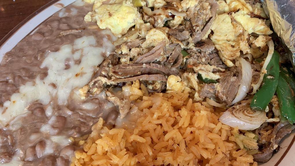 Huevos Machaca · Scrambled eggs with shredded beef and bell peppers. Served with rice and beans . Your choice of corn or flour tortillas