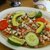Tostada · Your choice of chicken, ground beef or vegetarian. Open face corn tortilla with your choice ...