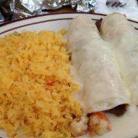 Surf and Turf Enchiladas (2) · Flour tortillas filled with fresh shrimp and carne asada. Topped with cheese, served with ei...
