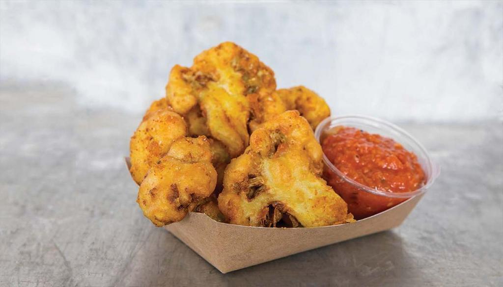 Fried Cauliflower · Cauliflower florets, beer battered & fried to a crisp golden brown and tossed with Dal seasoning.  Served with house-made tomato chutney.