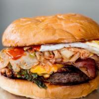 Impossible Kimchi Burger · Fried egg, kimchi, American cheese, Zoe's bacon & spicy gochujang mayo on a toasted egg bun.