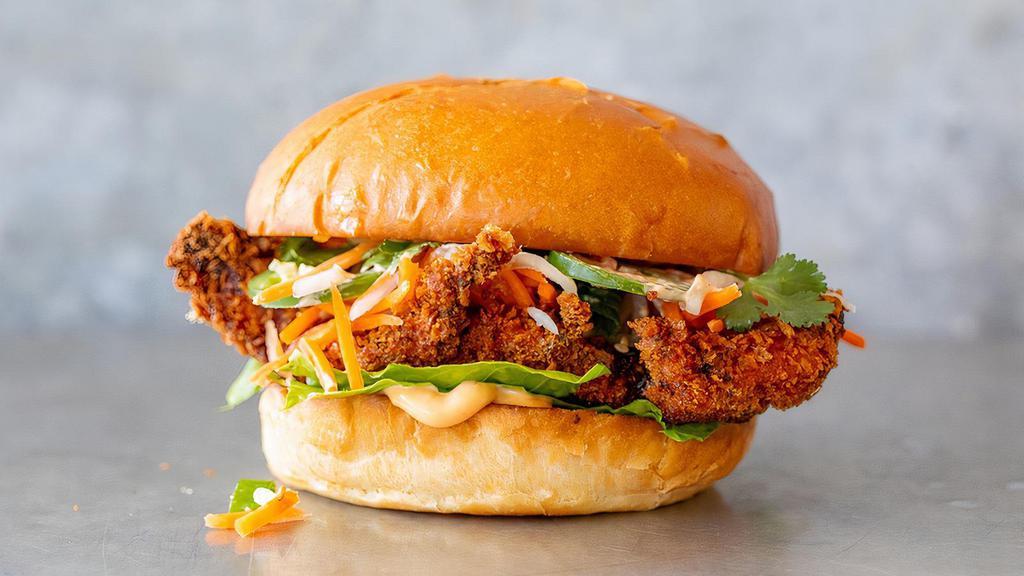 Crispy Teriyaki Chicken · Crispy fried chicken breast tossed in house-made teriyaki sauce & served with romaine lettuce, pickled carrots & daikon radishes, jalapeños, cilantro, green onions, toasted sesame seeds & spicy mayo on a toasted egg bun.