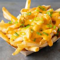 Cheese Fries · Topped with a creamy cheese sauce made with jalapeños & green onions.