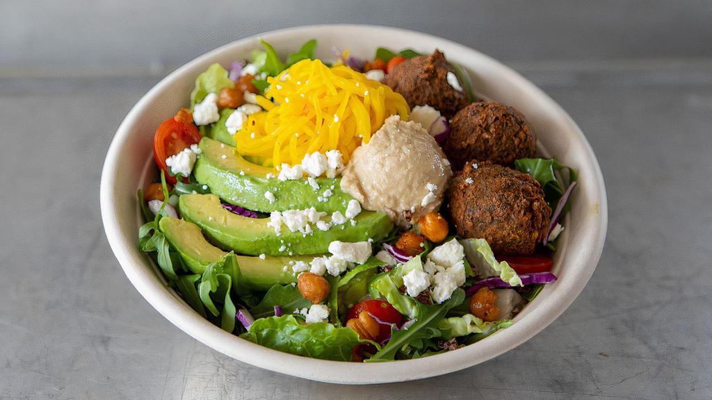 Falafel Salad · Arugula, romaine, red cabbage, tomatoes, cucumber & quinoa tossed with lemon tahini dressing & topped with spiced fried chickpeas, avocado, feta, pickled beets, hummus & falafel.