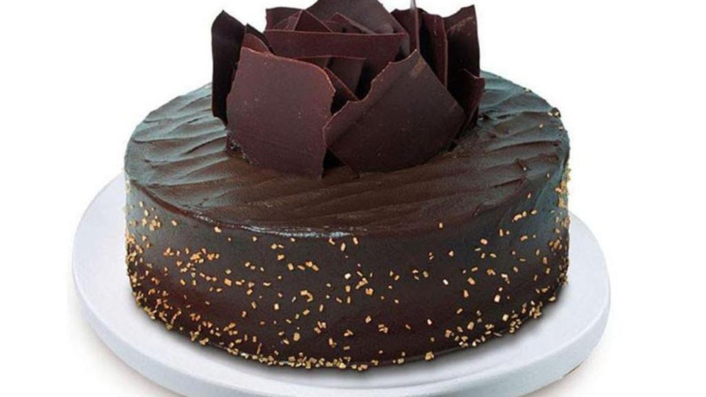 Chocolate Indulgence · Decadent chocolate pound cake with salted caramel filling, topped and finished with rich chocolate shavings and golden sugar.