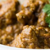 Chicken Curry (Boneless) · Chicken pieces slow-cooked in South Indian spices in rich onion sauce.