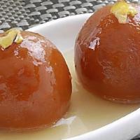 Gulab Jamun · Spongy milky balls soaked in sugar syrup.