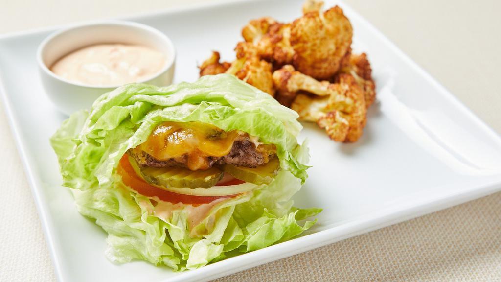 Keto Lettuce Wrapped Burger · Lettuce wrapped fresh grilled seasoned beef patty, cheddar, tomato, onion and pickles. Served with fried cauliflower and keto chipotle aioli. Gluten-free.