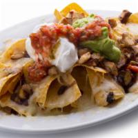 Super Nachos · Chips layered in cheese, topped with black beans, guacamole, sour crème & salsa choice of ch...