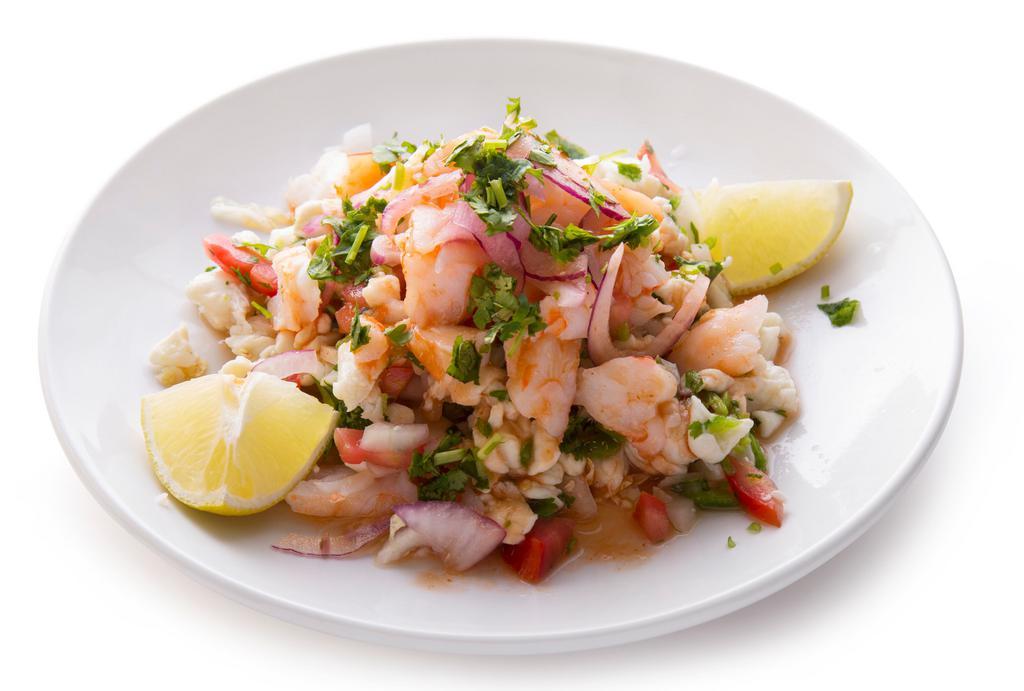 Ceviche · Shrimp marinated in lemon juice, tomatoes and white onions.
