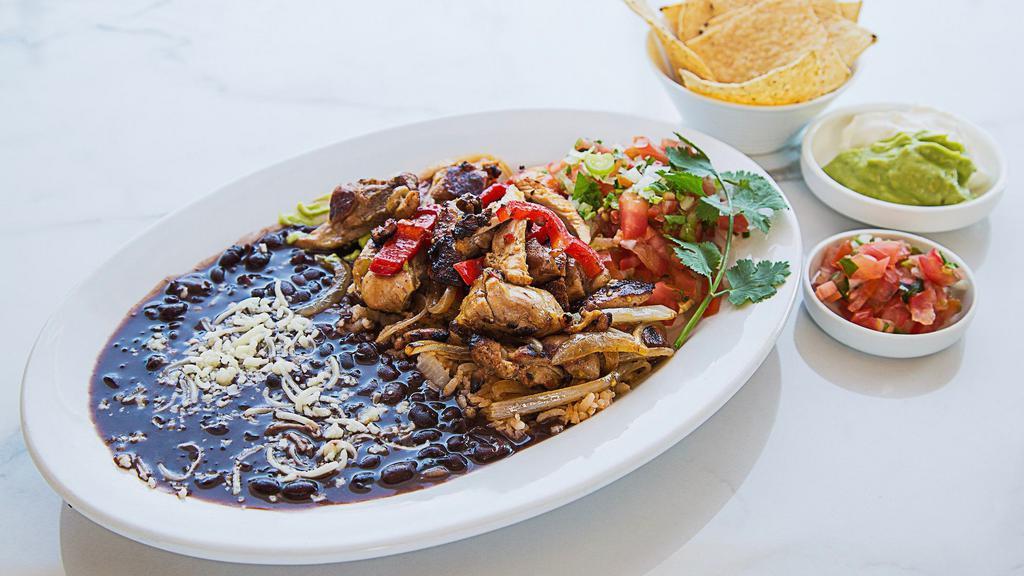 Chicken Fajitas · Served with Spanish rice and your choice of black or navy beans, corn or flour tortillas, sour cream and guacamole.