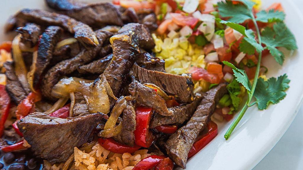 Steak Fajitas · Served with Spanish rice and your choice of black or navy beans, corn or flour tortillas, sour cream and guacamole.