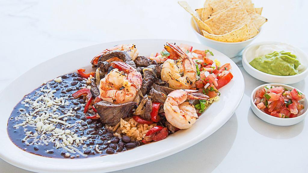 Steak & Shrimp Fajitas · Served with Spanish rice and your choice of black or navy beans, corn or flour tortillas, sour cream and guacamole.