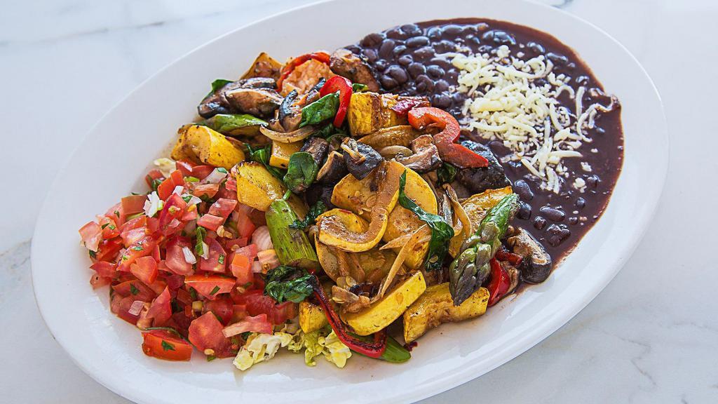 Veggie Fajitas · Served with Spanish rice and your choice of black or navy beans, corn or flour tortillas, sour cream and guacamole.