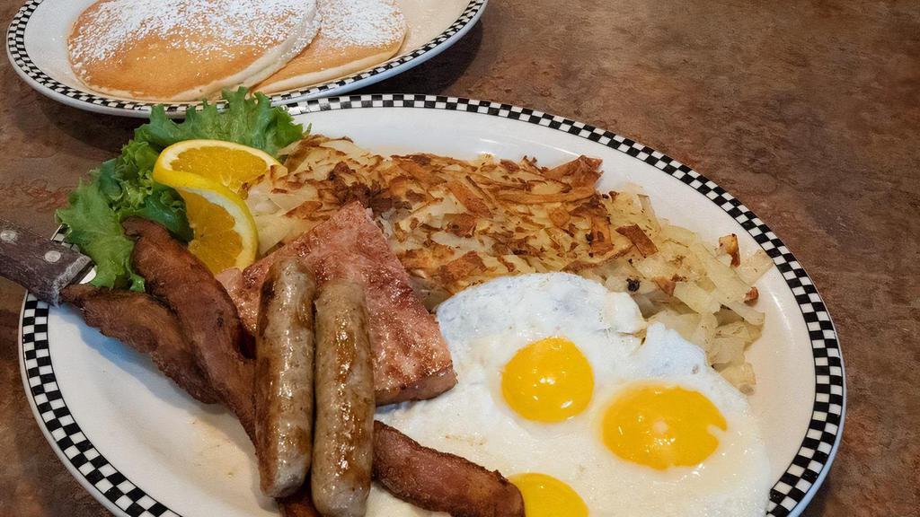 The Grizz · 2 sweet cream pancakes, 3 eggs*, 2 slices of bacon, 2 sausage links & a ham steak, served with your choice of potato..