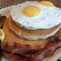 The Volcano · All stacked high!. 3 cakes, 2 link sausage, 2 slices of bacon, 2 eggs.