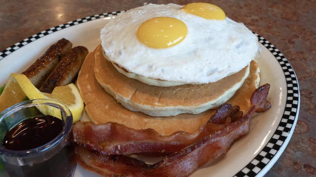 The Volcano · All stacked high!. 3 cakes, 2 link sausage, 2 slices of bacon, 2 eggs.