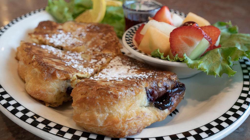 Stuffed Blackberry French Toast · Our fruit filled bear claw, dipped in egg batter* & griddled to perfection.  Served with fresh fruit.