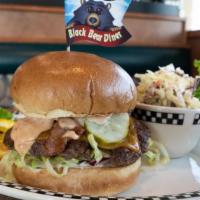 Bacon & Cheddar Burger · A 6 oz. all beef patty built on a golden brioche bun, shredded lettuce, tomato, diced red on...
