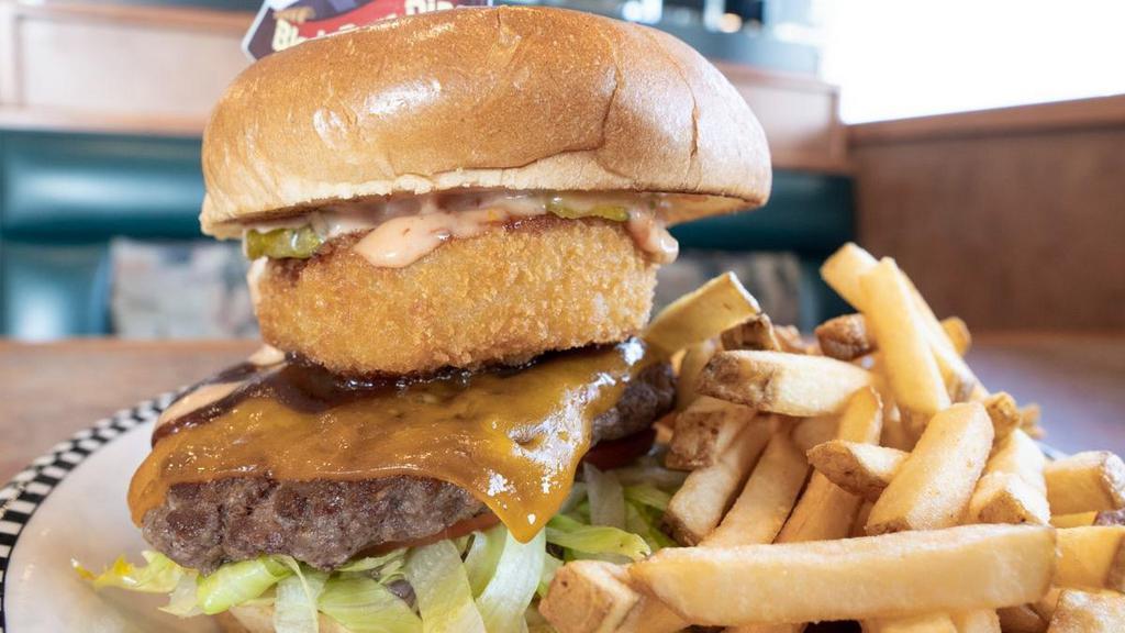 Western Bbq Burger · A 6 oz. all beef patty built on a golden brioche bun, shredded lettuce, tomato, diced red onion, dill pickle chips, mayonnaise & Thousand Island dressing.  . Covered in tangy BBQ sauce, cheddar cheese & deep-fried onion rings.
