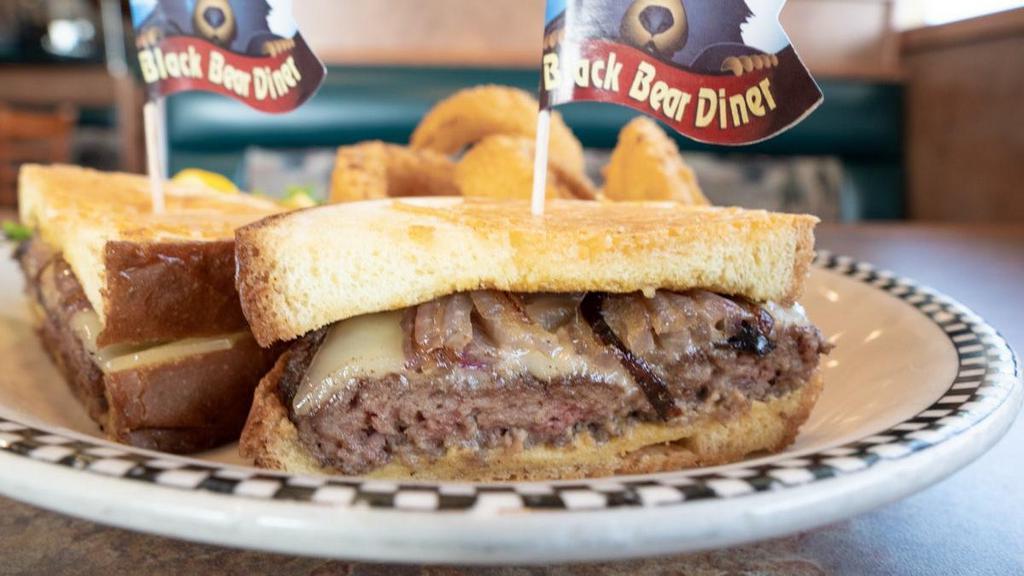Parmesan Sourdough Cheeseburger · We build this 6 oz. all beef burger just a little bit differently… Dijon mustard, Swiss cheese, tomato & grilled onion adorn thick-cut sourdough bread grilled golden with a garlic Parmesan cheese crust.
