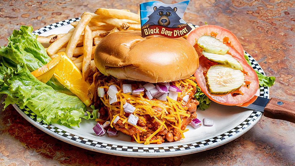 Chili Cheddar Cheeseburger · 6 oz burger topped with chili, cheddar cheese & diced red onion on a grilled brioche bun.  Served with green leaf lettuce, sliced tomato and pickles on the side.