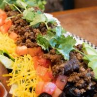 Taco Salad · Your choice of seasoned ground beef or marinated grilled chicken breast served in a crispy t...