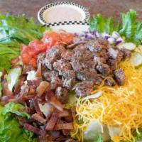 Bacon Cheeseburger Salad · All that’s missing is the bun in this perfect protein-style meal. Salad mix topped with a ch...