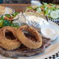 New York Steak* · 10 oz. steak topped with deep-fried onion rings.