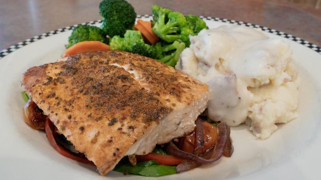 Blackened Salmon · Cajun seasoned, grilled salmon fillet served on a bed of sautèed spinach and cherry tomato.  Served with mashed potatoes with country gravy and seasonal vegetables.