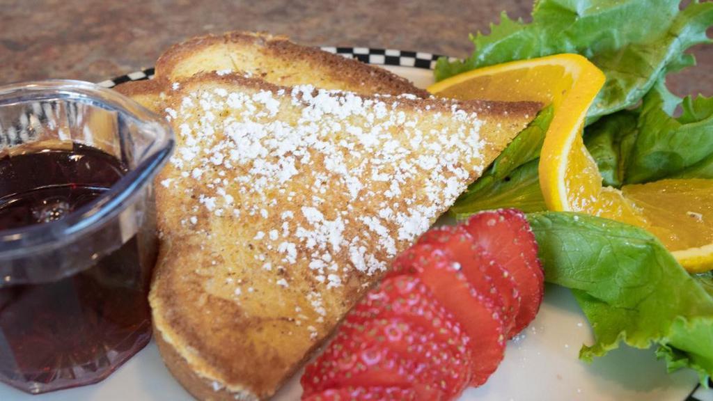 Cubs' Strawberry French Toast · One slice of thick-cut sourdough French toast topped with whipped cream.  Served with sliced strawberries and syrup.