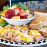 Cubs’ Scrambler · 1 scrambled egg with diced ham and cheddar cheese. Served with fresh fruit and toast.