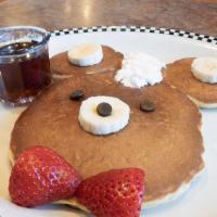 Happy Cub Cake · Sweet cream pancakes topped with banana, strawberry, chocolate chips and whipped cream.