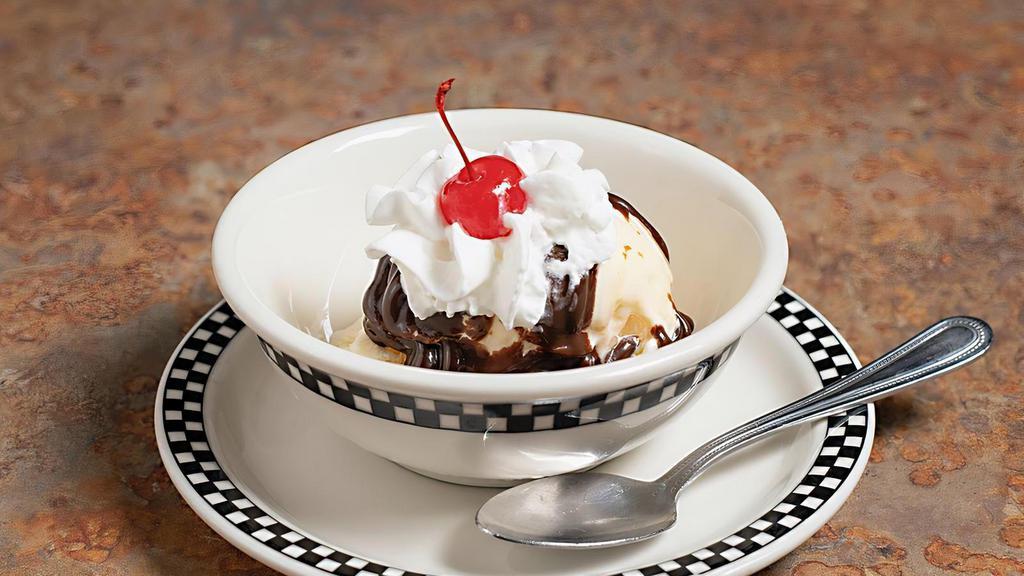 Hot Fudge Sundae · Hot Fudge Sundae with vanilla ice cream, whipped cream, nuts & maraschino cherry.