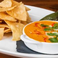 Queso Fundido · Queso Oaxaca, house chorizo, cilantro, pickled fresno chilis, cotija cheese and served with ...